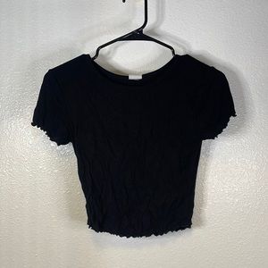 Ruffled on sleeves and bottom of shirt.